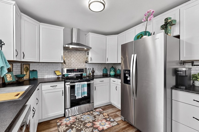 1008 County Road 4759, Sulphur Springs, TX 75482 - kitchen featuring stainless steel appliances, wall chimney range hood, dark countertops, and light wood-type flooring