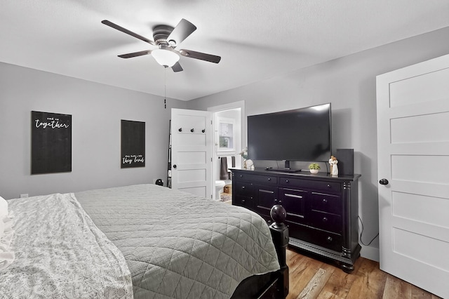 1008 County Road 4759, Sulphur Springs, TX 75482 - bedroom with wood finished floors, ceiling fan, and ensuite bath