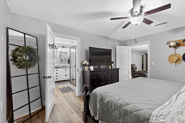 1008 County Road 4759, Sulphur Springs, TX 75482 - bedroom with light wood-type flooring, a ceiling fan, and ensuite bathroom