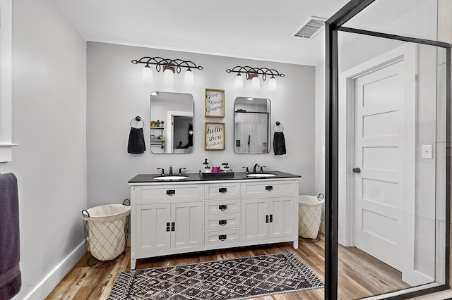 1008 County Road 4759, Sulphur Springs, TX 75482 - bathroom featuring wood finished floors and double vanity