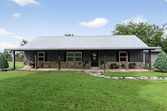 1008 County Road 4759, Sulphur Springs, TX 75482 - view of front of property with stone siding, board and batten siding, a front yard, and a metal roof