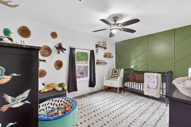 1008 County Road 4759, Sulphur Springs, TX 75482 - bedroom with a nursery area, wood finished floors, and a ceiling fan