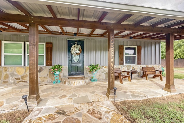 1008 County Road 4759, Sulphur Springs, TX 75482 - doorway to property featuring stone siding, board and batten siding, and covered porch