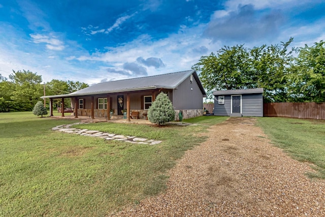 1008 County Road 4759, Sulphur Springs, TX 75482 - view of front of property with driveway, a storage unit, and a metal roof