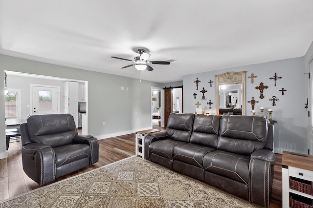 1008 County Road 4759, Sulphur Springs, TX 75482 - living area featuring wood finished floors, ceiling fan, and a barn door