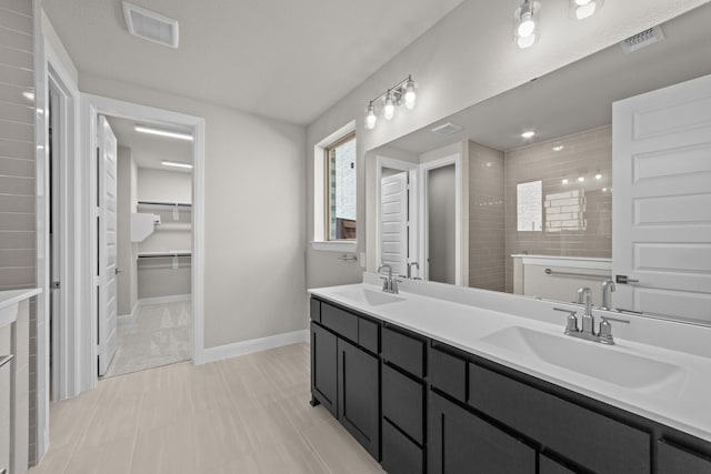 6217 Escarpment Dr, Fort Worth, TX 76112 - bathroom featuring double vanity, a spacious closet, and tile patterned flooring