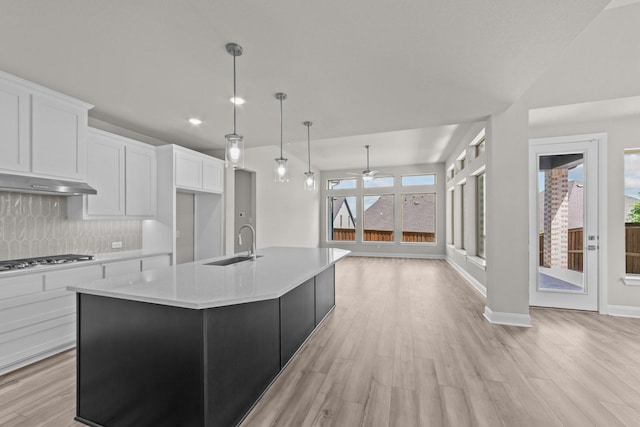 6217 Escarpment Dr, Fort Worth, TX 76112 - kitchen with stainless steel gas stovetop, ceiling fan, light countertops, tasteful backsplash, and light wood-style floors