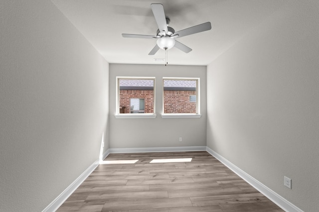 6217 Escarpment Dr, Fort Worth, TX 76112 - empty room with ceiling fan, wood finished floors, and a textured wall