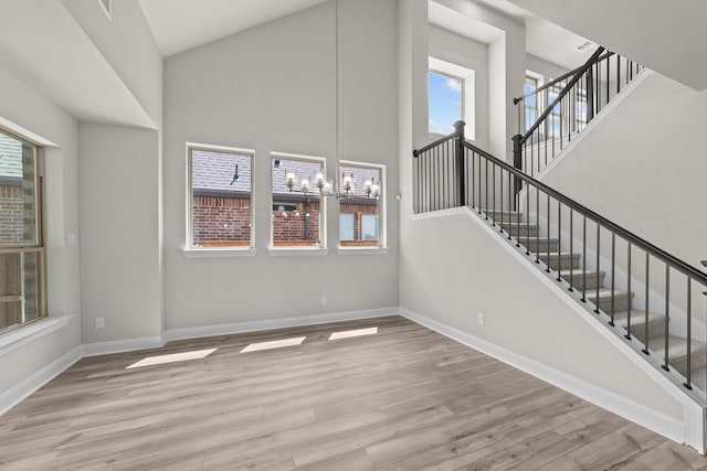 6217 Escarpment Dr, Fort Worth, TX 76112 - unfurnished living room featuring a high ceiling, wood finished floors, and healthy amount of natural light