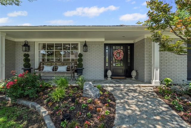 7116 Serrano Dr, Benbrook, TX 76126 - view of exterior entry with covered porch and brick siding