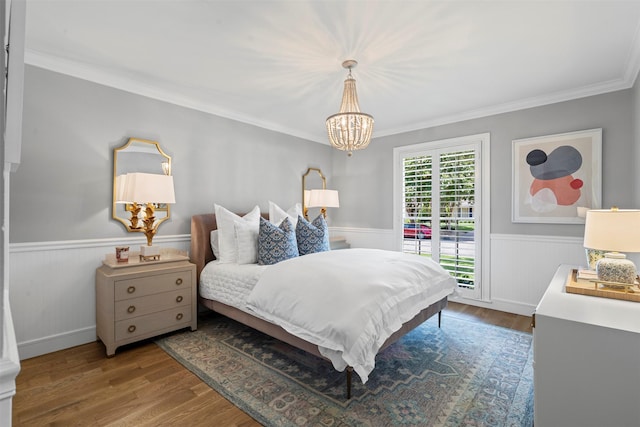 7116 Serrano Dr, Benbrook, TX 76126 - bedroom featuring a chandelier, a wainscoted wall, crown molding, and wood finished floors