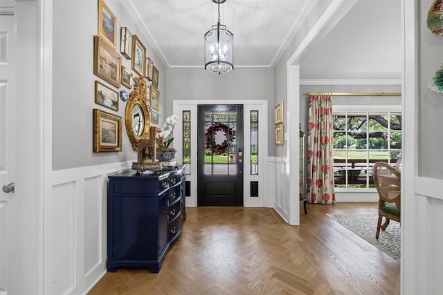 7116 Serrano Dr, Benbrook, TX 76126 - foyer entrance featuring ornamental molding, wainscoting, a chandelier, a decorative wall, and wooden ceiling