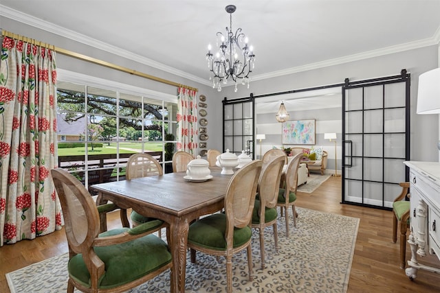 7116 Serrano Dr, Benbrook, TX 76126 - dining area with a barn door, ornamental molding, a chandelier, and wood finished floors