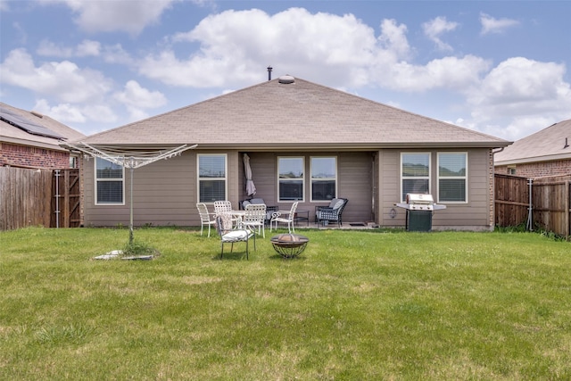 4319 Pyramid Dr, Forney, TX 75126 - back of house with a fire pit, a fenced backyard, and roof with shingles