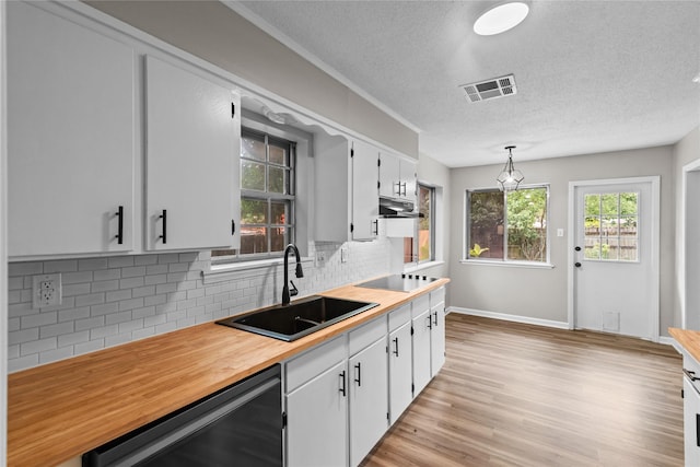 9709 Monticello Dr, Shreveport, LA 71118 - kitchen featuring dishwasher, under cabinet range hood, black electric stovetop, a textured ceiling, and tasteful backsplash