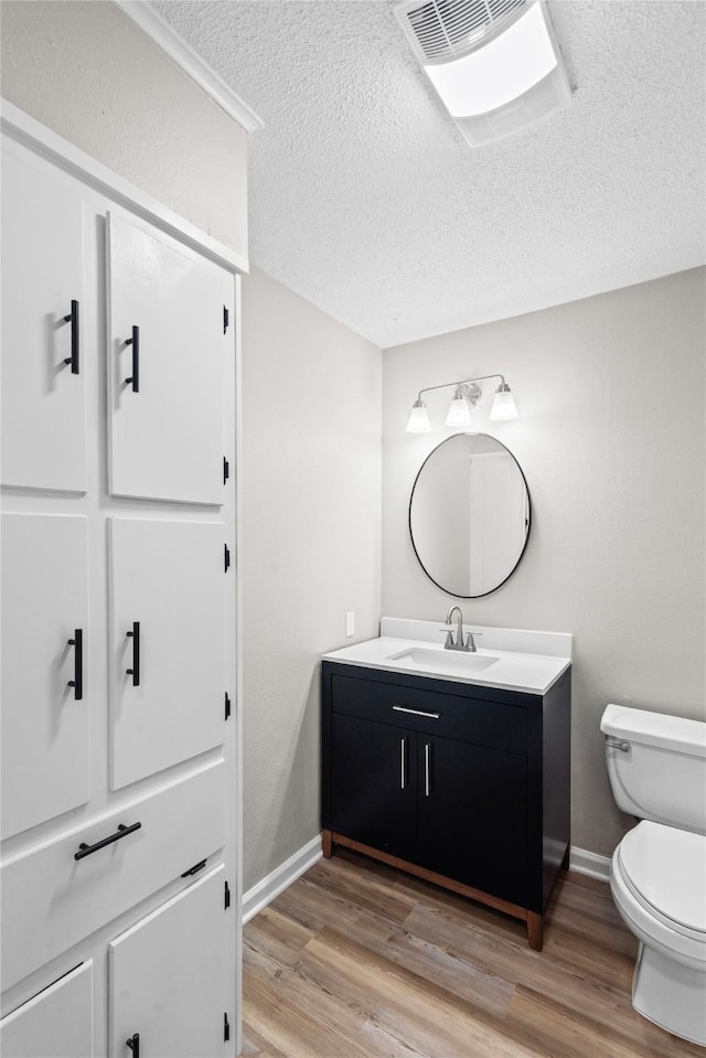 9709 Monticello Dr, Shreveport, LA 71118 - bathroom featuring vanity, wood finished floors, and a textured ceiling