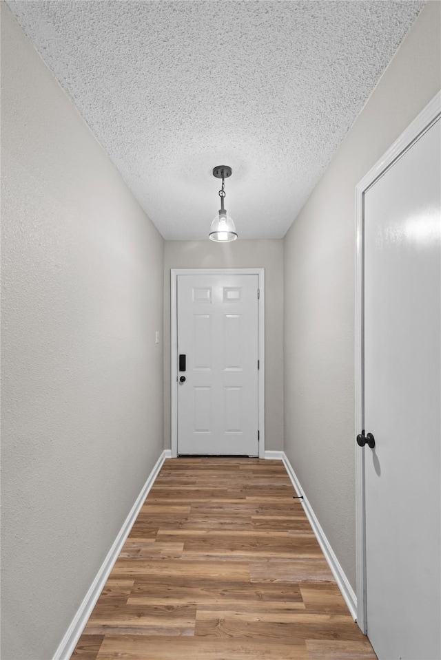 9709 Monticello Dr, Shreveport, LA 71118 - doorway to outside with wood finished floors and a textured ceiling