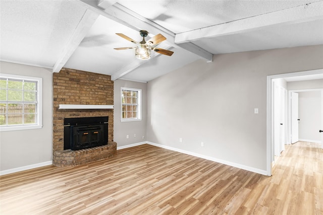 9709 Monticello Dr, Shreveport, LA 71118 - unfurnished living room with light wood-style flooring, healthy amount of natural light, ceiling fan, a textured ceiling, and a brick fireplace