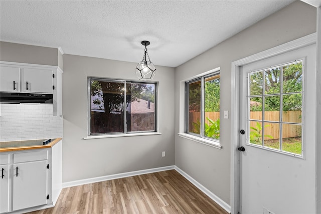 9709 Monticello Dr, Shreveport, LA 71118 - unfurnished dining area featuring light wood-style floors and a textured ceiling