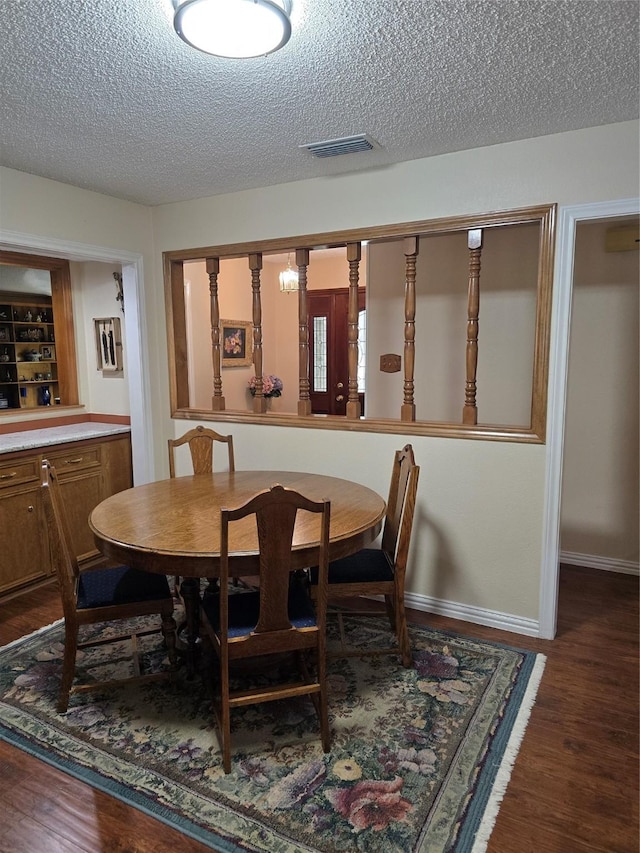 3810 Lucena Ct, Grand Prairie, TX 75052 - dining space featuring a textured ceiling and dark wood-type flooring