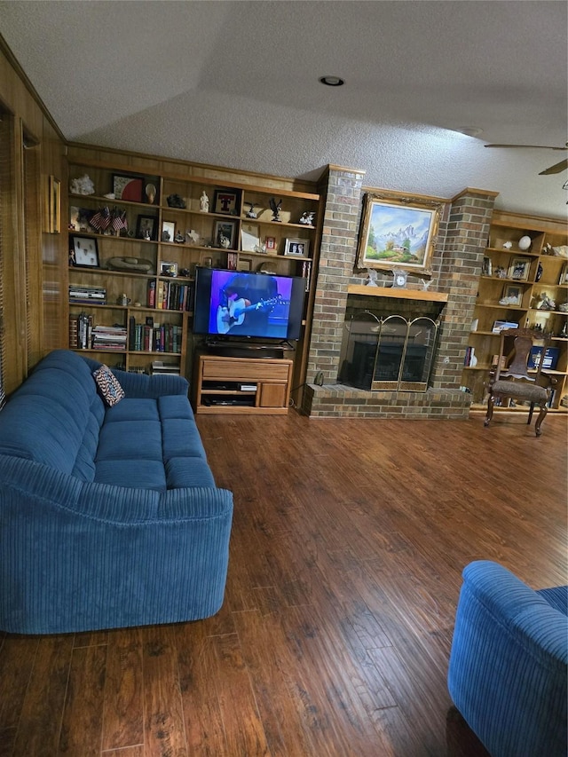 3810 Lucena Ct, Grand Prairie, TX 75052 - living area with wood finished floors, vaulted ceiling, a brick fireplace, built in shelves, and a textured ceiling