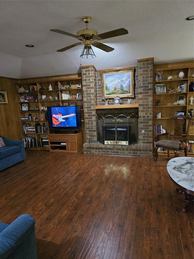 3810 Lucena Ct, Grand Prairie, TX 75052 - living area with wood-type flooring, a brick fireplace, a textured ceiling, and ceiling fan