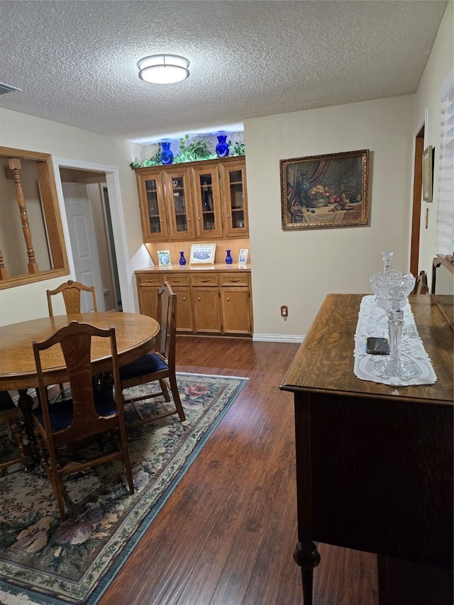 3810 Lucena Ct, Grand Prairie, TX 75052 - dining space with a textured ceiling and dark wood-style floors