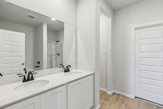 535 Forest Hvn, Van Alstyne, TX 75495 - full bathroom featuring a shower stall, double vanity, and wood finished floors