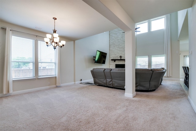 11100 Tanager Ln, Cross Roads, TX 76227 - carpeted living area featuring a chandelier, plenty of natural light, a fireplace, and a towering ceiling