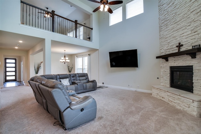 11100 Tanager Ln, Cross Roads, TX 76227 - living room featuring carpet flooring, a chandelier, a ceiling fan, a towering ceiling, and a fireplace