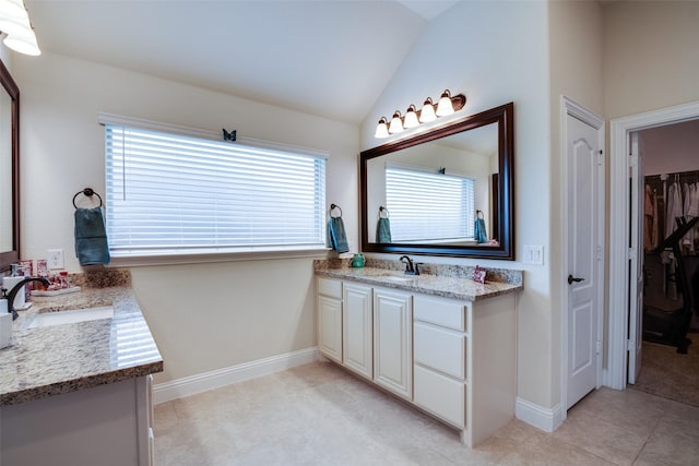 11100 Tanager Ln, Cross Roads, TX 76227 - full bath with two vanities, lofted ceiling, a spacious closet, and tile patterned floors