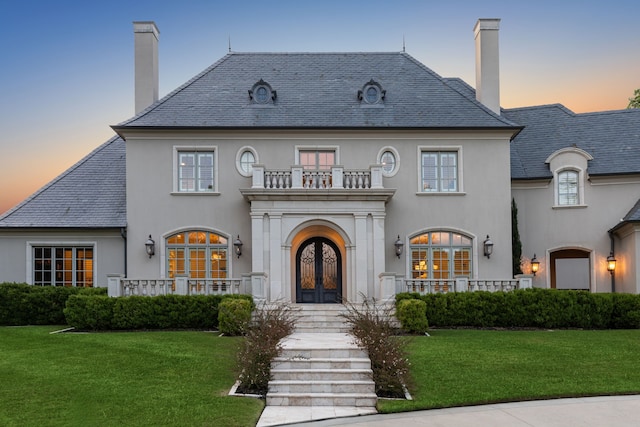 4715 W NW Hwy, Dallas, TX 75220 - view of front facade featuring french doors, a high end roof, a balcony, and a chimney