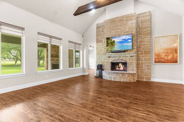1707 Ponderosa Trl, Sachse, TX 75048 - unfurnished living room with high vaulted ceiling, wood finished floors, a fireplace, and beamed ceiling