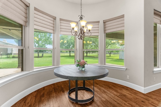 1707 Ponderosa Trl, Sachse, TX 75048 - dining area featuring healthy amount of natural light, a chandelier, and wood finished floors