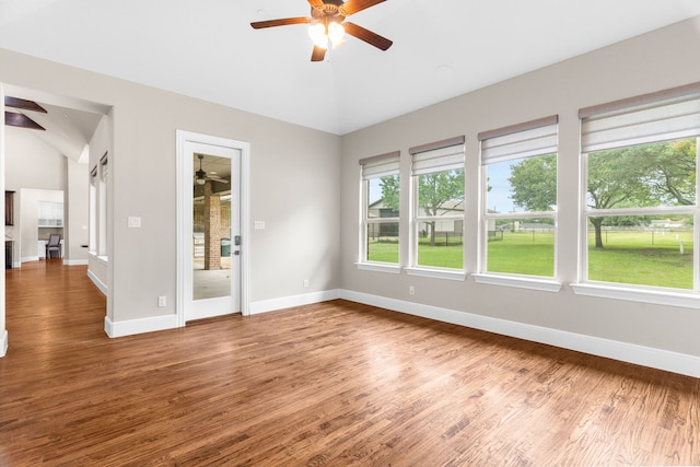1707 Ponderosa Trl, Sachse, TX 75048 - unfurnished room featuring ceiling fan, vaulted ceiling, plenty of natural light, and wood finished floors