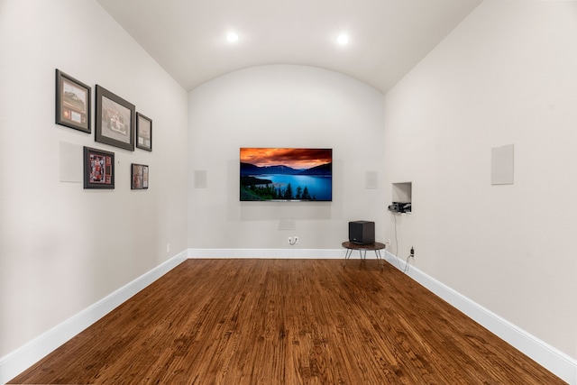1707 Ponderosa Trl, Sachse, TX 75048 - home theater with dark wood-style floors, vaulted ceiling, and recessed lighting
