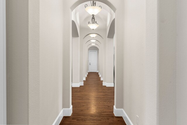 1707 Ponderosa Trl, Sachse, TX 75048 - hall featuring arched walkways and dark wood-style floors