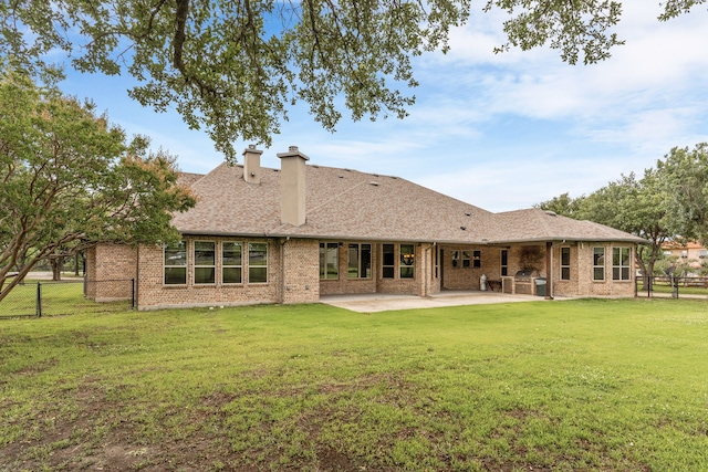 1707 Ponderosa Trl, Sachse, TX 75048 - back of house featuring brick siding, a patio, a shingled roof, and a chimney