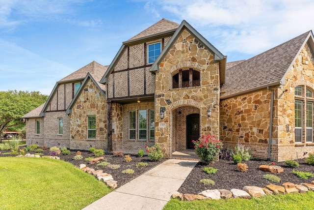 1707 Ponderosa Trl, Sachse, TX 75048 - tudor-style house featuring stone siding, a front lawn, and brick siding