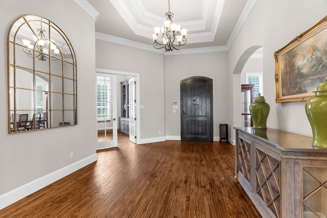 1707 Ponderosa Trl, Sachse, TX 75048 - foyer featuring a chandelier, arched walkways, healthy amount of natural light, dark wood-style floors, and ornamental molding
