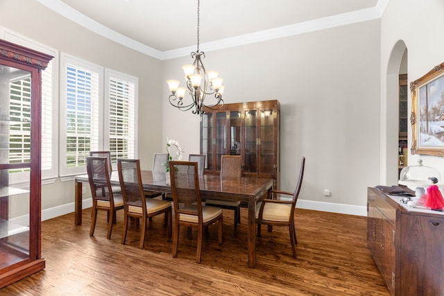 1707 Ponderosa Trl, Sachse, TX 75048 - dining space featuring arched walkways, a chandelier, wood finished floors, and crown molding