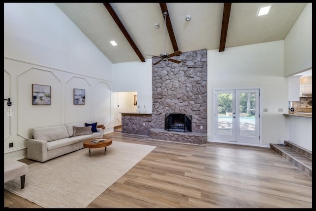 5016 Kemble St, Fort Worth, TX 76103 - living room featuring ceiling fan, high vaulted ceiling, light wood-style flooring, beam ceiling, and a fireplace