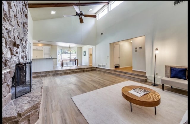 5016 Kemble St, Fort Worth, TX 76103 - living area with a ceiling fan, high vaulted ceiling, wood finished floors, a fireplace with raised hearth, and a chandelier
