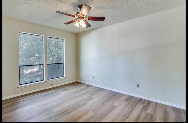5016 Kemble St, Fort Worth, TX 76103 - empty room with a textured ceiling, wood finished floors, and a ceiling fan