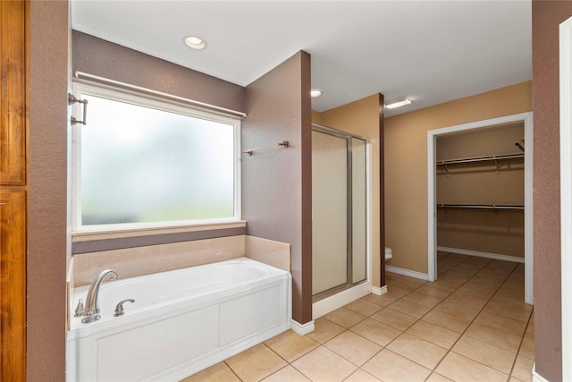 875 Cr221, Stephenville, TX 76401 - bathroom with a shower stall, a bath, tile patterned flooring, and a spacious closet