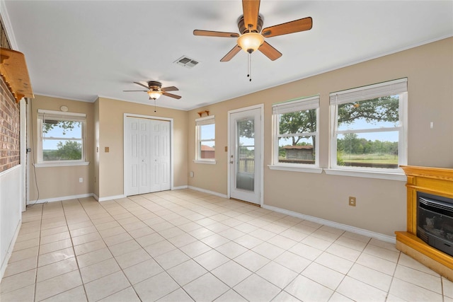 875 Cr221, Stephenville, TX 76401 - unfurnished living room with ceiling fan, plenty of natural light, ornamental molding, and light tile patterned floors