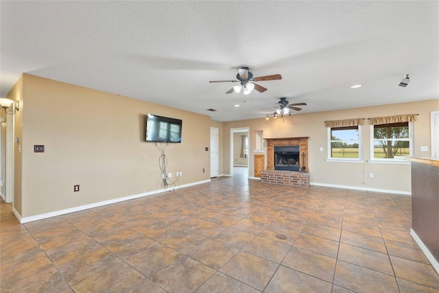 875 Cr221, Stephenville, TX 76401 - unfurnished living room featuring a ceiling fan, a brick fireplace, and recessed lighting