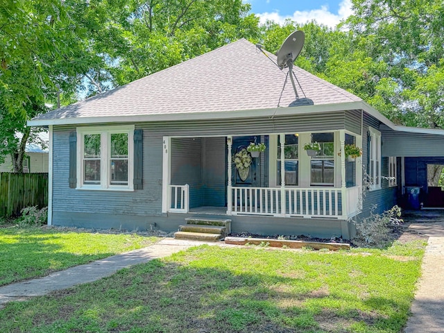 408 S Throckmorton Ave, Kerens, TX 75144 - view of front facade featuring a porch, an attached carport, and roof with shingles