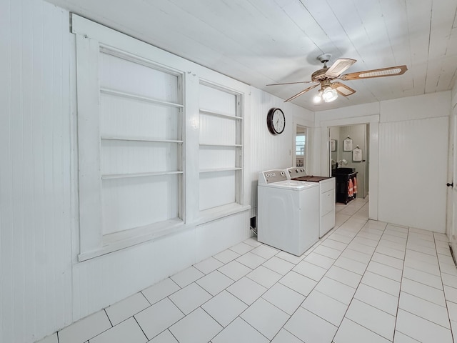 408 S Throckmorton Ave, Kerens, TX 75144 - laundry room featuring washing machine and dryer, ceiling fan, light tile patterned flooring, and wooden walls