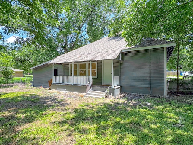 408 S Throckmorton Ave, Kerens, TX 75144 - view of front of home with covered porch and a shingled roof
